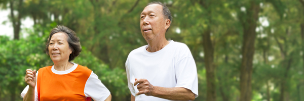 elderly couple brisk walking outdoors