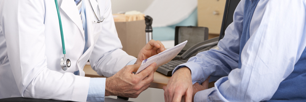 doctor speaking to a male patient in office